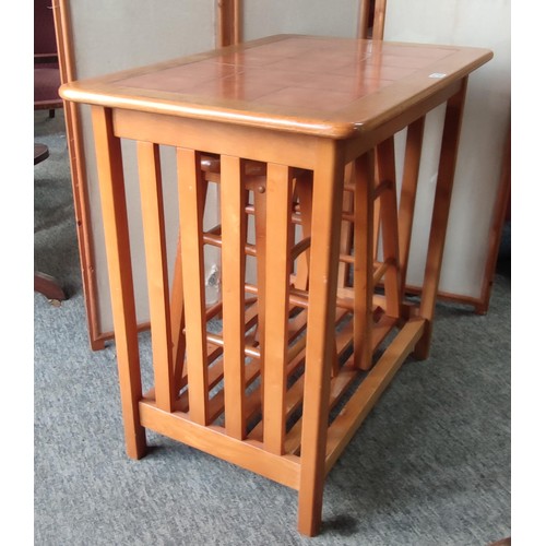 A wooden breakfast table with a rectangular top inset with twelve ...