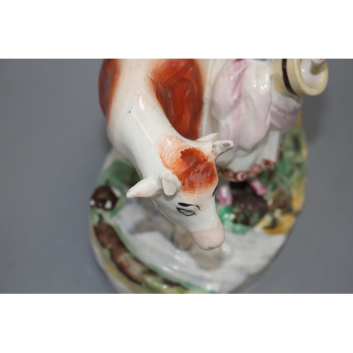 116 - A Staffordshire pottery group of a milkmaid and cow, L. 21cm Condition: Loss to cow's right horn and... 