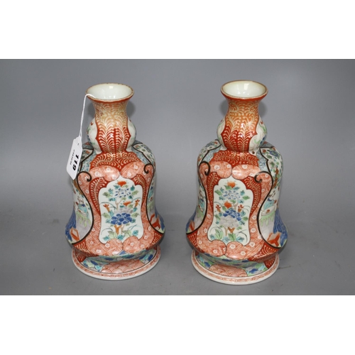 119 - A pair of Japanese enamelled porcelain huqqa base vases, decorated with figures, height 25cm Conditi... 