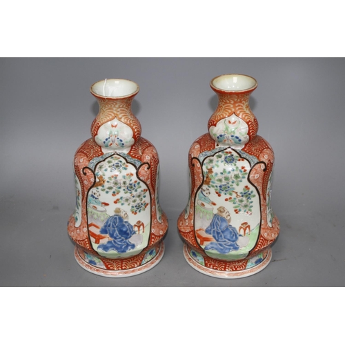 119 - A pair of Japanese enamelled porcelain huqqa base vases, decorated with figures, height 25cm Conditi... 