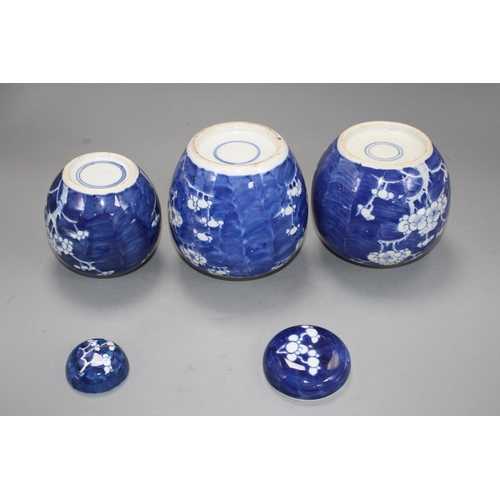 148 - Three Chinese blue and white 'prunus' jars and two covers, early 20th century, height 12cm - 13.5cm ... 