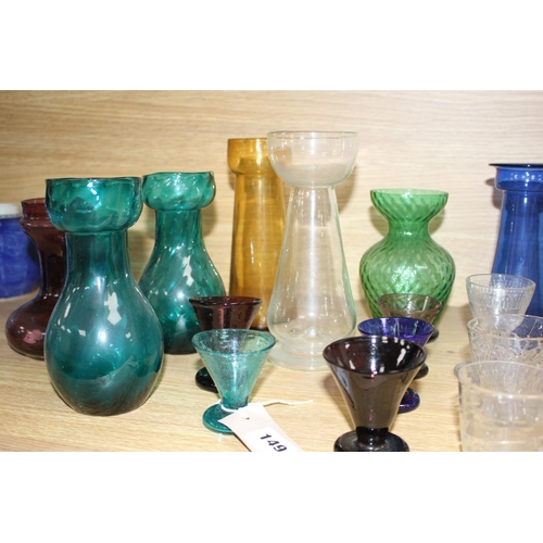 149 - Seven assorted Edwardian coloured glass hyacinth vases, a slender specimen vase and a thirteen other... 