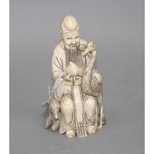 15 - A Chinese carved ivory group of a sage holding a peach, seated beside a crane and a deer, 17cm Condi... 