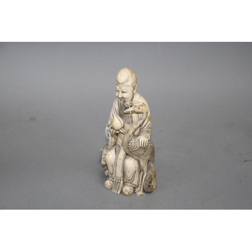 15 - A Chinese carved ivory group of a sage holding a peach, seated beside a crane and a deer, 17cm Condi... 