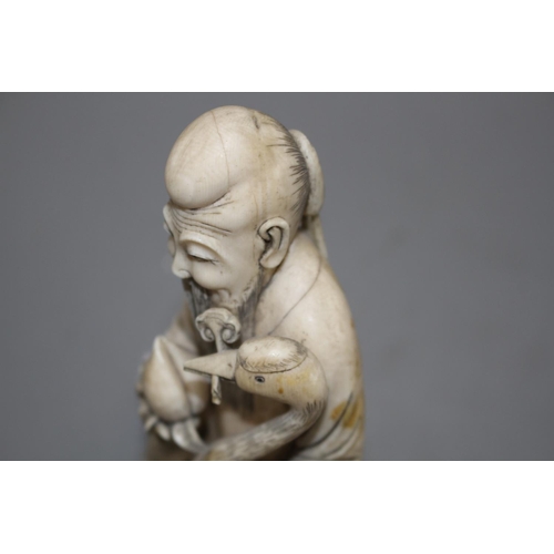 15 - A Chinese carved ivory group of a sage holding a peach, seated beside a crane and a deer, 17cm Condi... 