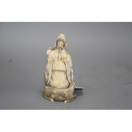 15 - A Chinese carved ivory group of a sage holding a peach, seated beside a crane and a deer, 17cm Condi... 