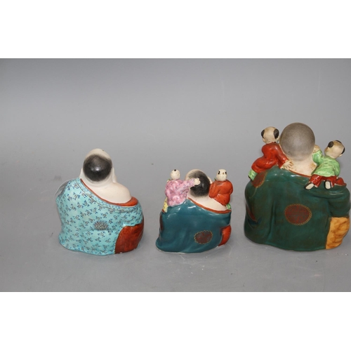 156 - Three Chinese famille rose groups of Budai, mid 20th century, two modelled with children and with im... 