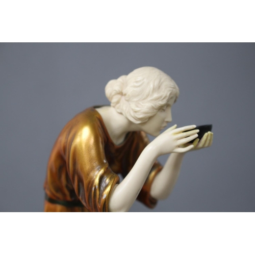 171 - An Art Deco style resin figure of a lady, height 28cm Condition: Lacks one foot, hairline crack at t... 