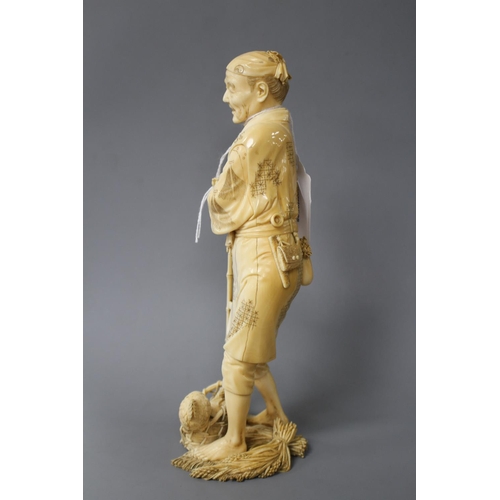 172 - A Japanese ivory Tokyo School ivory okimono, carved as a farmer above a chicken, Meiji period, signe... 