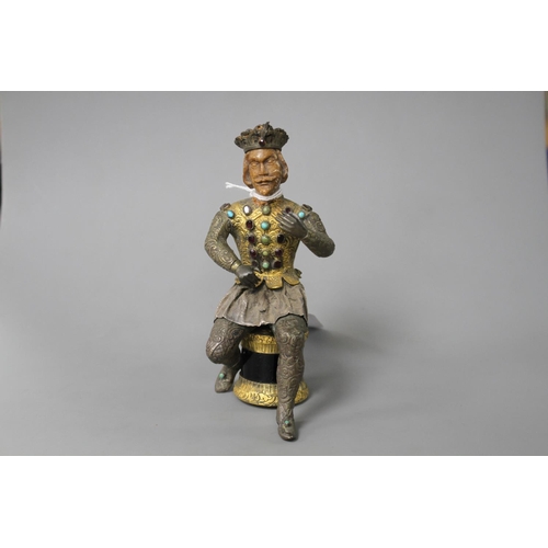 175 - An Austro-Hungarian gilt and white metal figure of a seated knight, with jewelled decoration and har... 