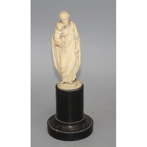 18 - A 19th century Dieppe carved ivory figure of St Joseph holding the Christ child, 16cm, on ebony socl... 