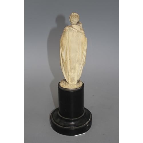 18 - A 19th century Dieppe carved ivory figure of St Joseph holding the Christ child, 16cm, on ebony socl... 