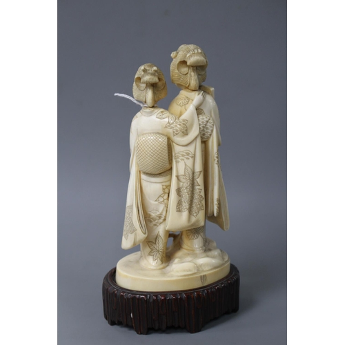 182 - A Japanese Tokyo School carved ivory group of two geisha, late Meiji period, signed, height 18cm, ov... 