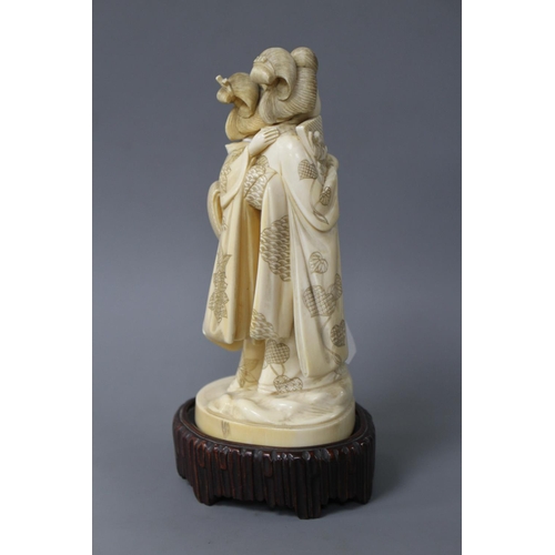 182 - A Japanese Tokyo School carved ivory group of two geisha, late Meiji period, signed, height 18cm, ov... 