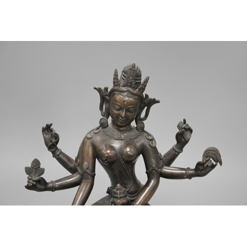 29 - A Sino-Tibetan bronze figure of a seated female deity, on associated marble plinth, height 35cm Cond... 