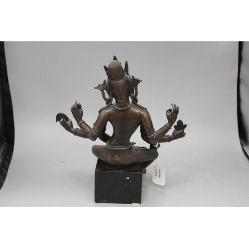 29 - A Sino-Tibetan bronze figure of a seated female deity, on associated marble plinth, height 35cm Cond... 