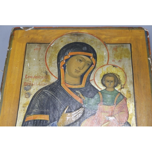 31 - A 19th century Russian tempera on wood icon, 31 x 26cm and another smaller icon, 17.5 x 13cm Conditi... 