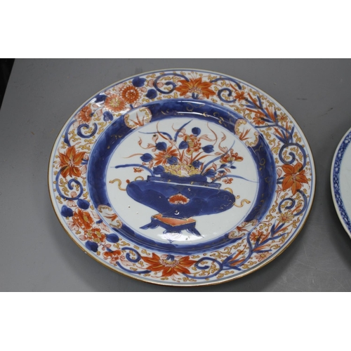 32 - A Chinese Imari plate decorated with flowers in an urn, 25cm and a blue and white plate, 23cm Condit... 