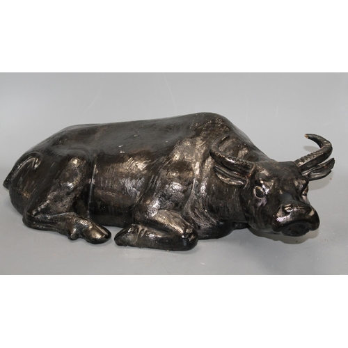 46 - A Chinese black glazed pottery model of a seated water buffalo, length 56cm Condition: Tips of both ... 