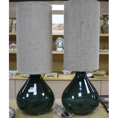 52 - A pair of green glass lamp bases with cylindrical fabric shades, height overall 94cm, diameter 34cm ... 