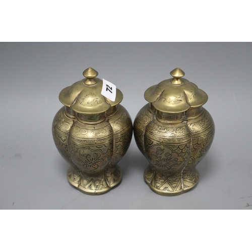 72 - A pair of Chinese brass vases and covers, decorated with figures, cast seal marks to the bases, heig... 