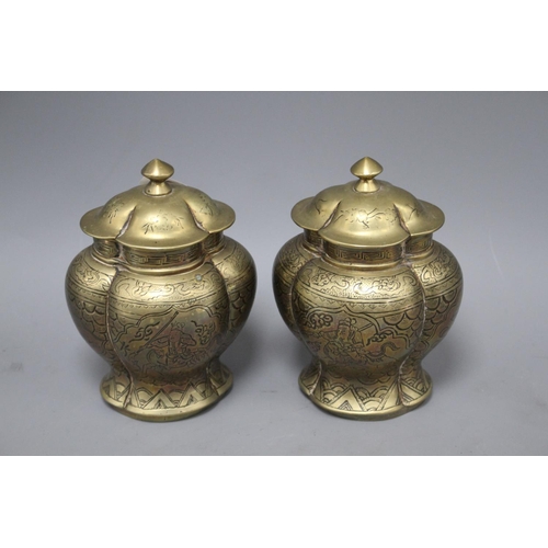 72 - A pair of Chinese brass vases and covers, decorated with figures, cast seal marks to the bases, heig... 