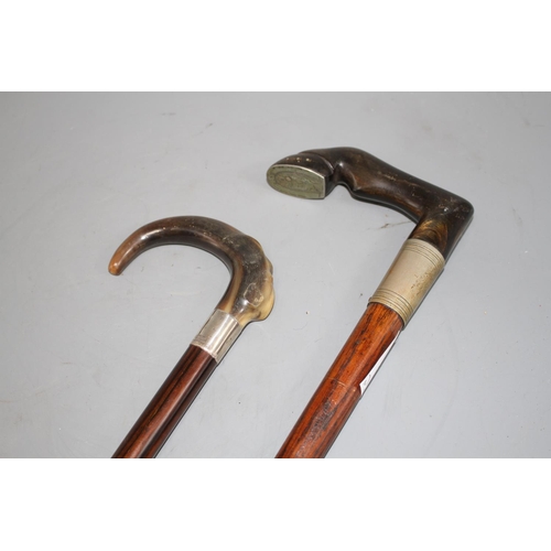 73 - An Edwardian oak walking stick with pewter mounted horn horse hoof handle, 84cm and an ebony walking... 