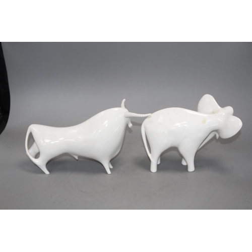 75 - A Royal Dux white glazed bull and an elephant, L. 26 and 21cm Condition: Loss to tip of bull's left ... 