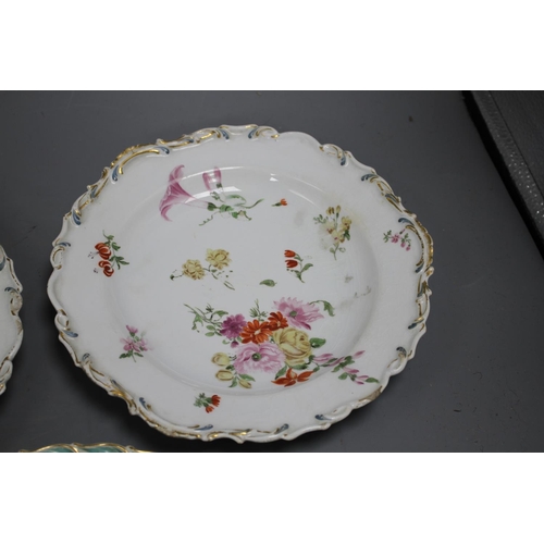 85 - A Chelsea gold anchor 'bird and insect' plate and a similar pair of floral plates, c. 1765, 22 and 2... 