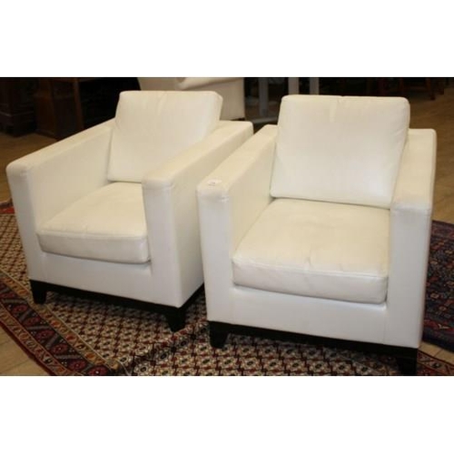 876 - A pair of modern Italian cream leather upholstered armchairs, with ebonised feet, W.80cm D.90cm H.86... 