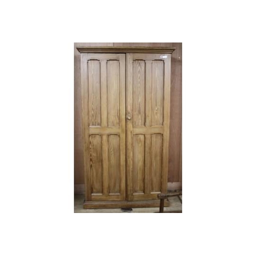 884 - An Edwardian pitched pine hall cupboard, with two panelled doors enclosing two fixed shelves and fit... 