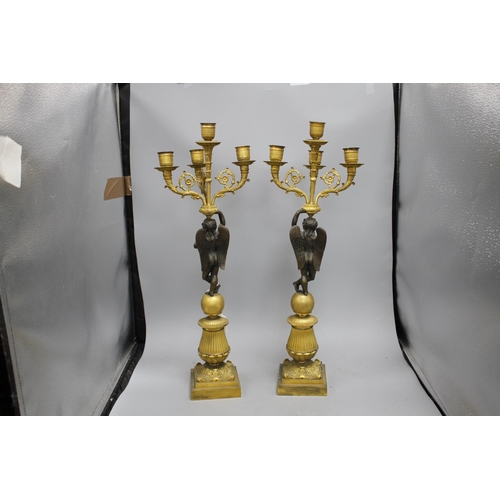 93 - A pair of 19th century French bronze and ormolu candelabra, with scrolling branches, cherub stems an... 