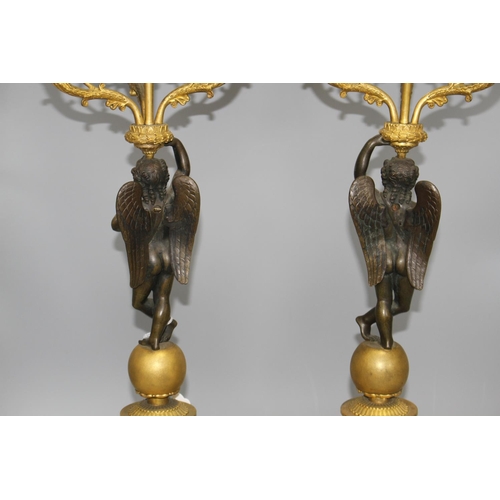 93 - A pair of 19th century French bronze and ormolu candelabra, with scrolling branches, cherub stems an... 