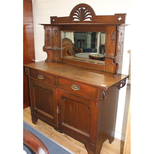 887 - An Edwardian Maple & Co oak chiffonier, with mirrored back, two drawers and two panelled doors, W.13... 