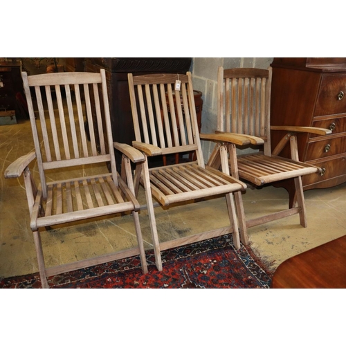 1001 - Three teak folding garden armchairs