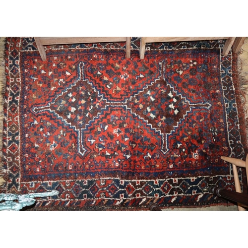 1002 - A Qashqai red ground rug, 140 x 110cm