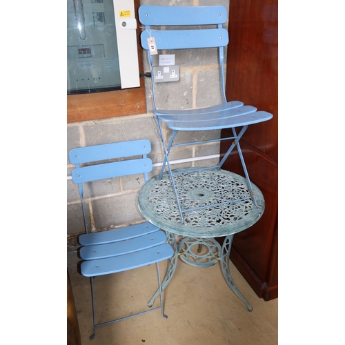 1022 - A painted aluminium circular garden table, 60cm diameter together with a pair of folding chairs... 