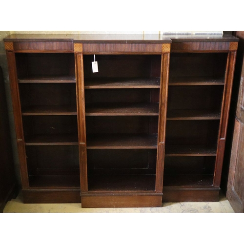 1028A - An Edwardian mahogany breakfront open bookcase, W.154cm, D.27cm, H.128cm