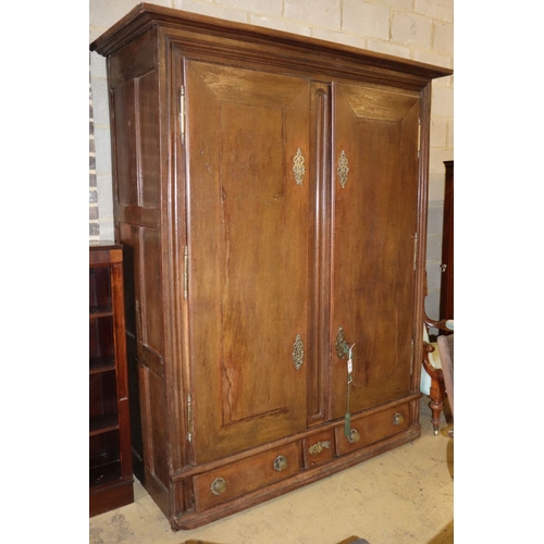 1029 - An 18th century Normandy oak two door armoire with brass escutcheons and buttressed hinges, W.178cm,... 