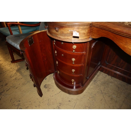 1035 - A Victorian mahogany serpentine kneehole writing desk, W.136cm, D.56cm, H.74cm
