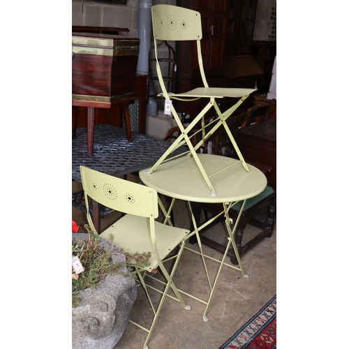 1042 - A folding painted circular garden table, 69cm diameter and pair of folding chairs