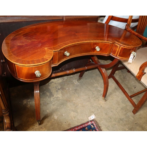 1046 - A reproduction mahogany kidney shaped dressing table, W.100cm, D.54cm, H.69cm