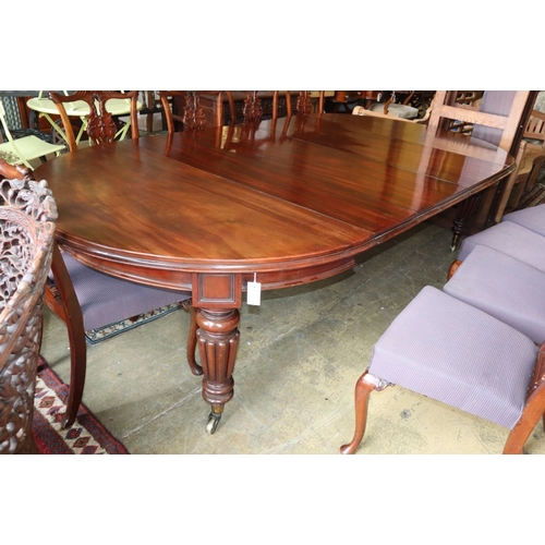 1058 - A Victorian mahogany extending dining table by Edwards and Roberts, together with an oak table leaf ... 