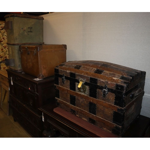 1083 - An early 20th century metal bound domed topped steamer trunk, W.76cm, a leather bound trunk and anot... 