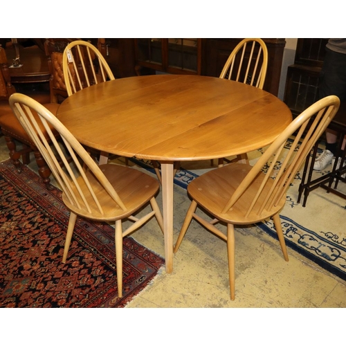 1155 - An Ercol circular elm and beech drop leaf dining table, 110cm diameter and four Ercol Windsor beech ... 