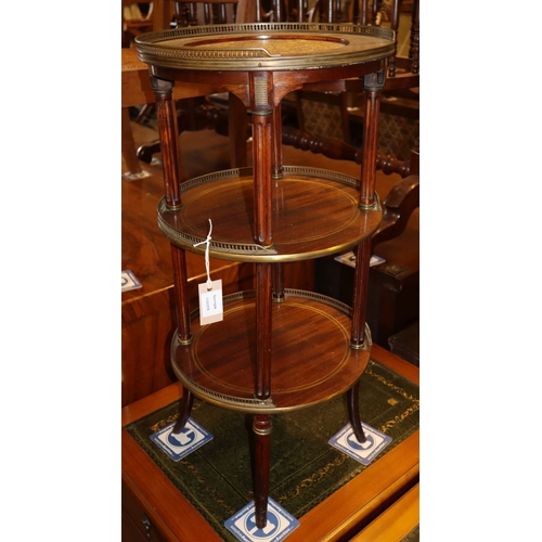 1171 - A late 19th century French circular mahogany and brass three tier etagere, 36cm diameter, H.76cm... 