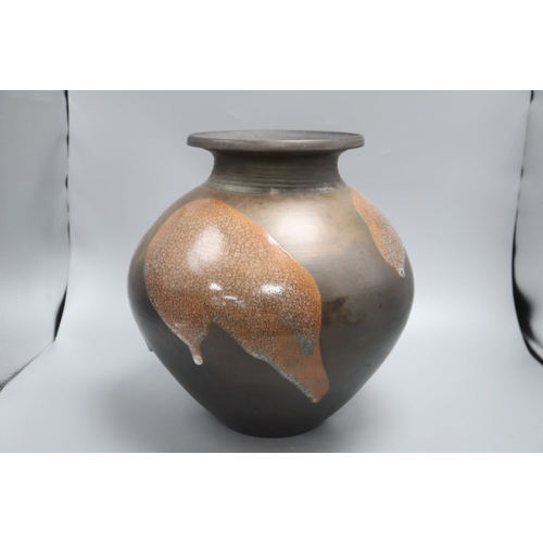 1234 - A Raku glazed studio pottery jug by Tim Andrews, height 34cm