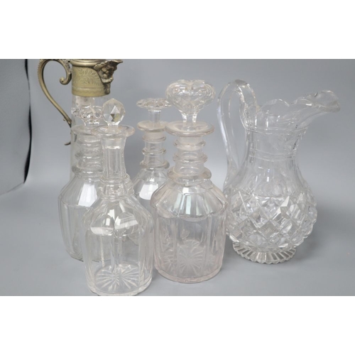 1276 - Four glass decanters, a claret jug and another jug, tallest 34cm