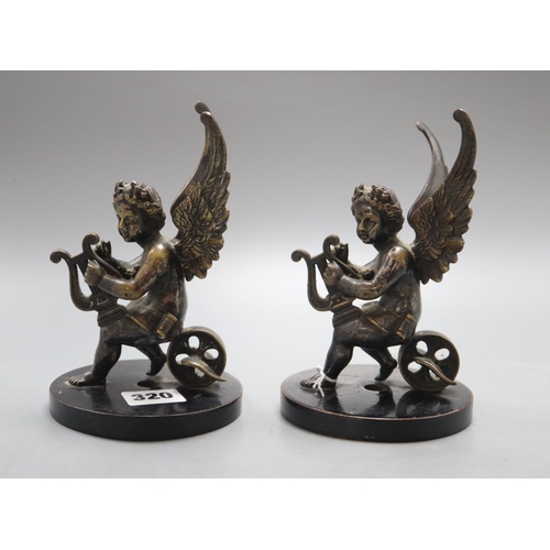 1320 - A pair of 19th century bronze cherub bookends, height 16cm