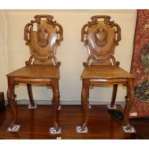 54 - A pair of Victorian oak hall chairs